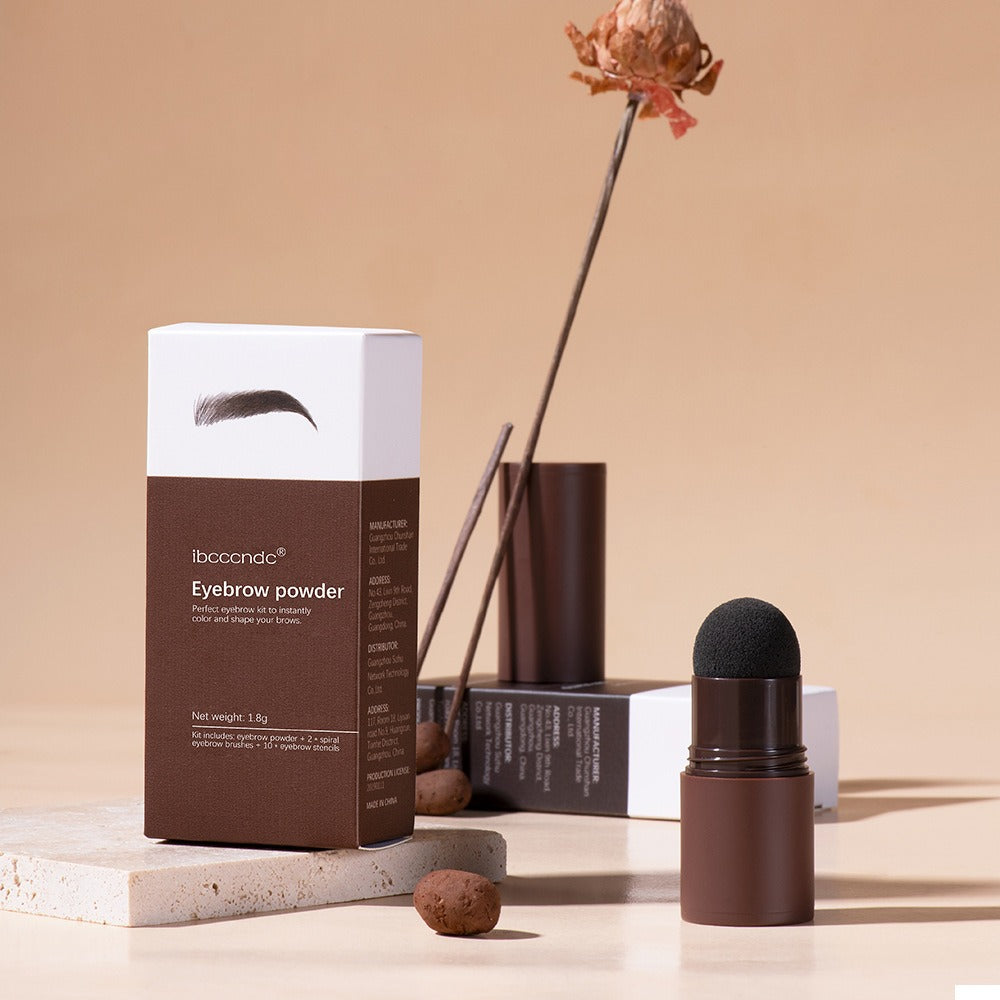 Brown eyebrow powder in a cardboard box next to a brown plastic container with a sponge tip applicator.