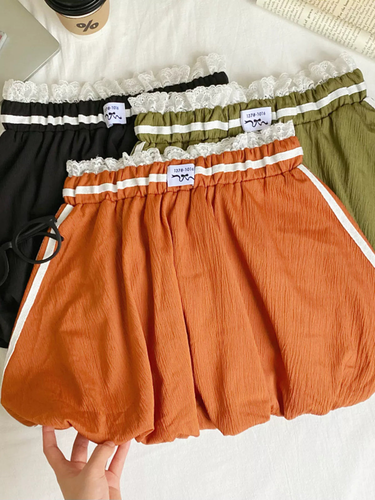 Lace trim elastic waist mini skirt from Plush Fashion Hub showing a stylish, fitted design with decorative lace details.