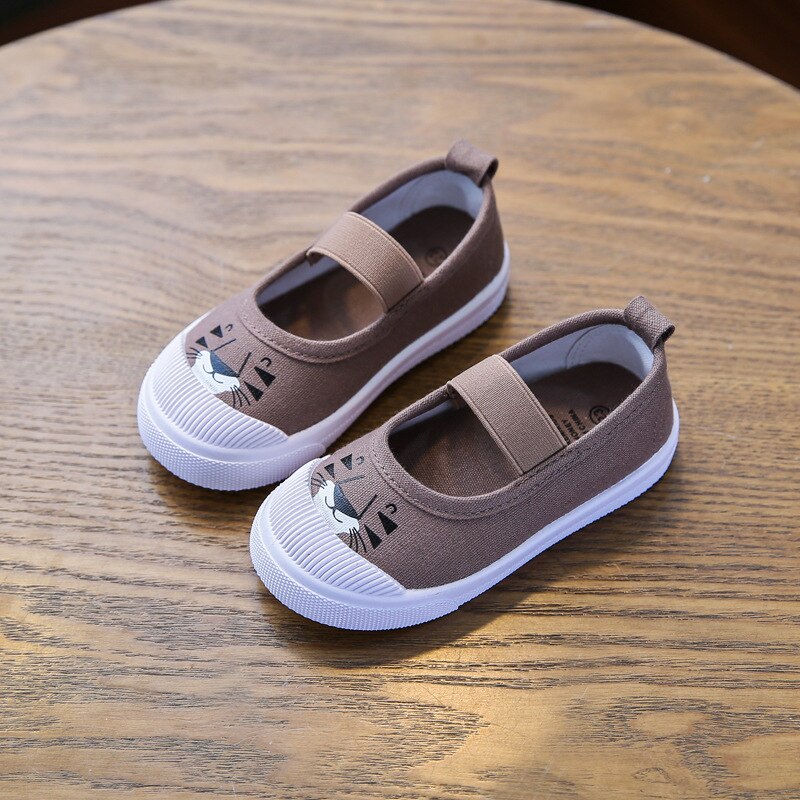 Brown canvas slip-on kids' shoes featuring a cute animal face print on the toe, elastic strap, and white rubber sole.