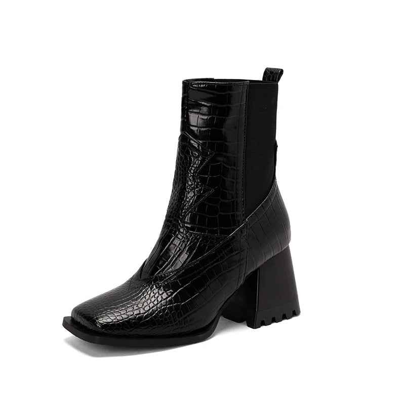 Black square toe ankle boot with crocodile pattern leather, chunky heel, and elastic side panel.