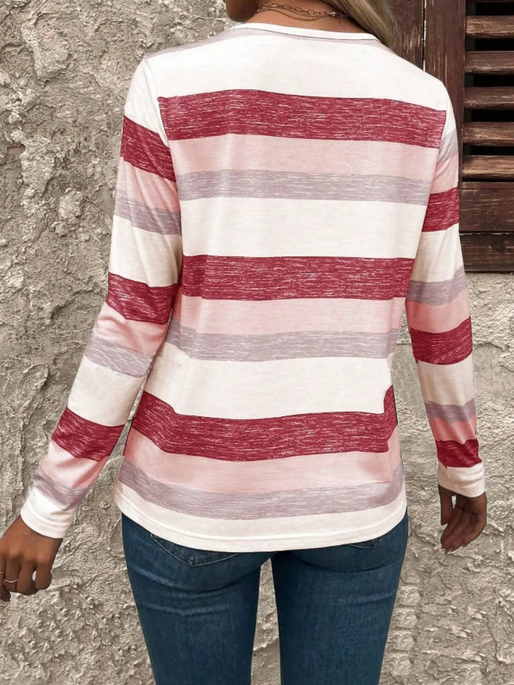 Contrast striped V-neck long sleeve T-shirt from Plush Fashion Hub featuring bold black and white stripes and a relaxed fit.