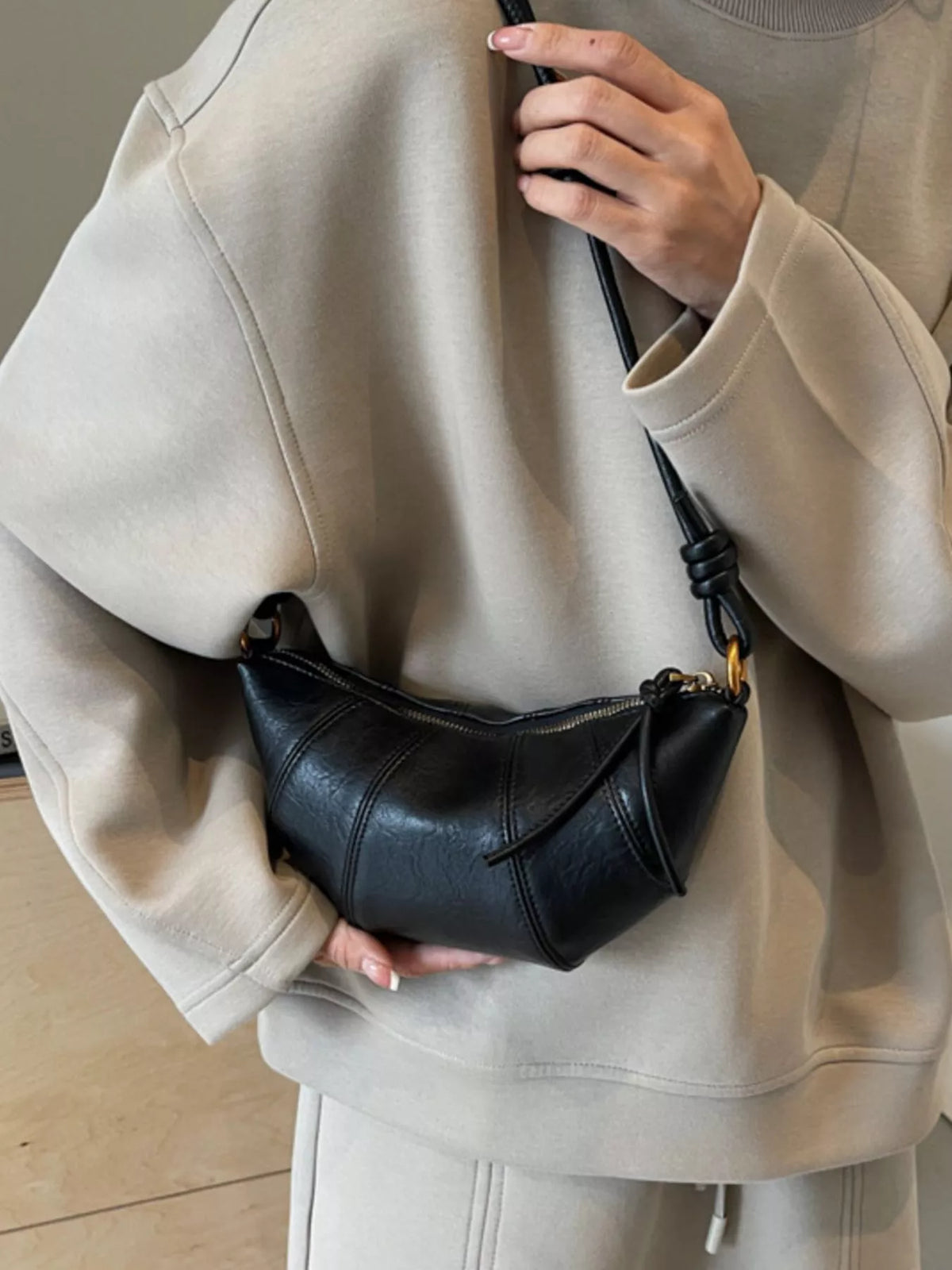 Plush Fashion Hub croissant-shaped crossbody bag with soft plush material and detailed stitching, stylish accessory for casual wear.