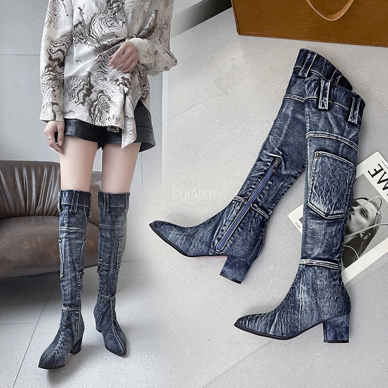 Dark blue denim over-the-knee boots featuring a pointed toe, block heel, cargo pocket, and belt-loop details.