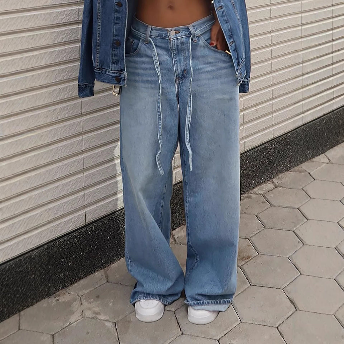 Washed denim high-waisted straight-leg jeans with tied waist detail from Plush Fashion Hub, shown on a model.