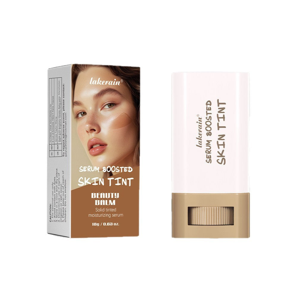 Lakerain white and tan serum boosted skin tint balm in a twist-up plastic stick with its matching box.