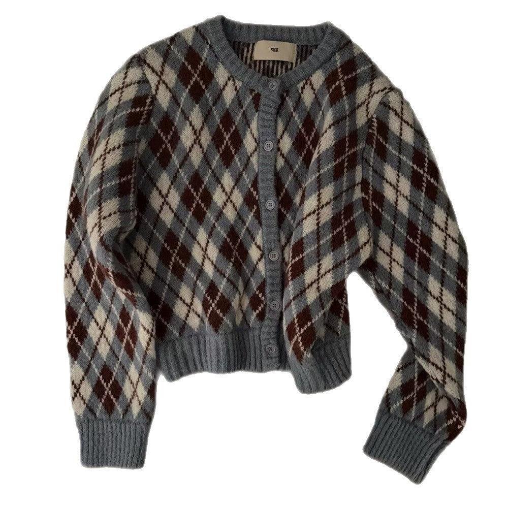 A grey, brown, and white argyle patterned knit button-up sweater with a round neck is laid flat.