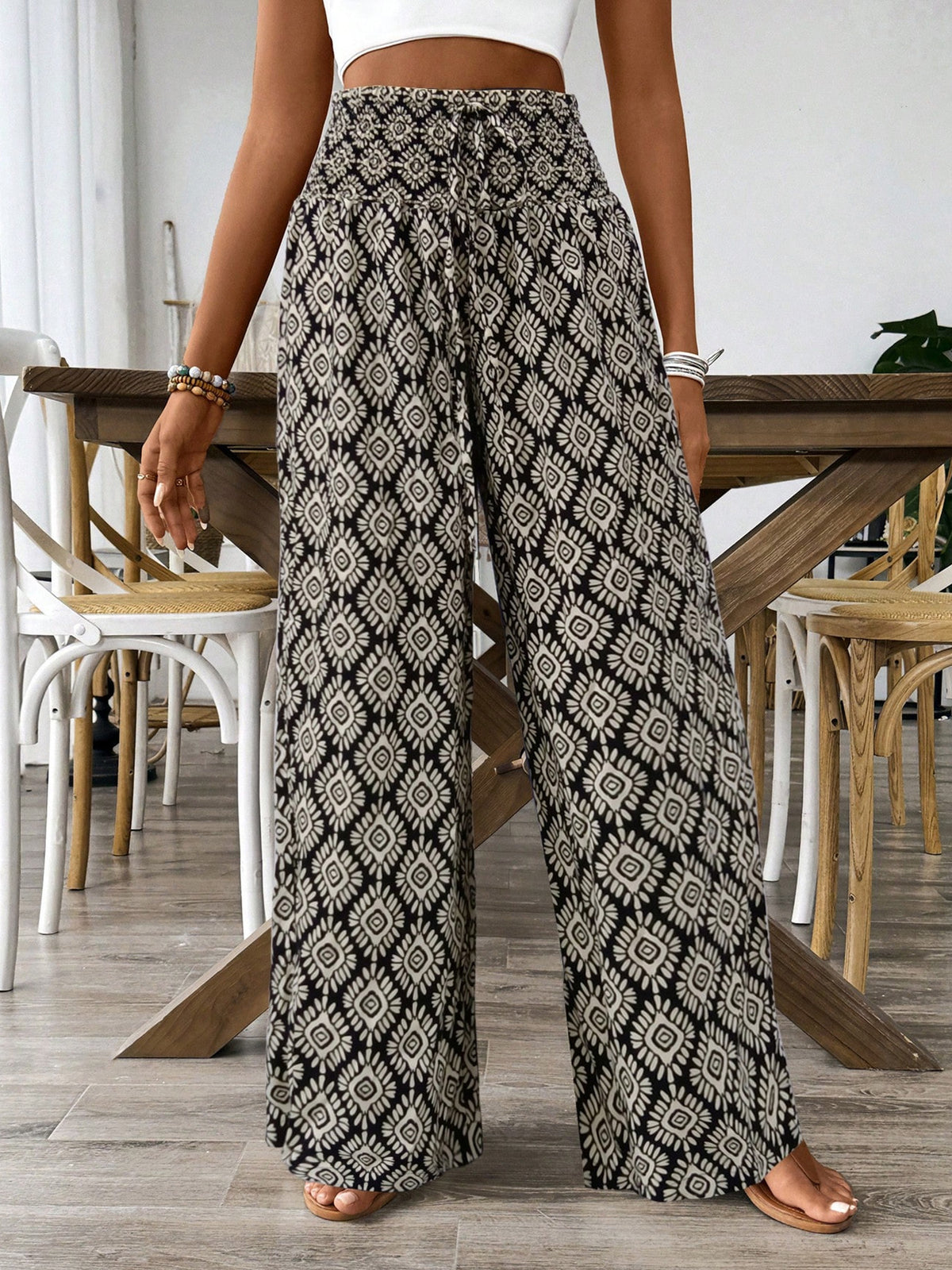 Women’s printed wide-leg tie waist pants by Plush Fashion Hub, lightweight high-waist trousers with stylish pattern and relaxed fit.