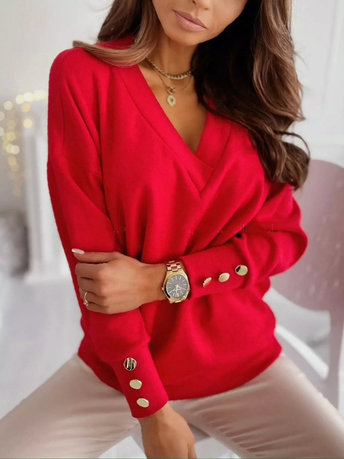 Women’s V-neck button cuff blouse by Trendsi, featuring a stylish V-neck design, button cuffs, and a flowy fabric.