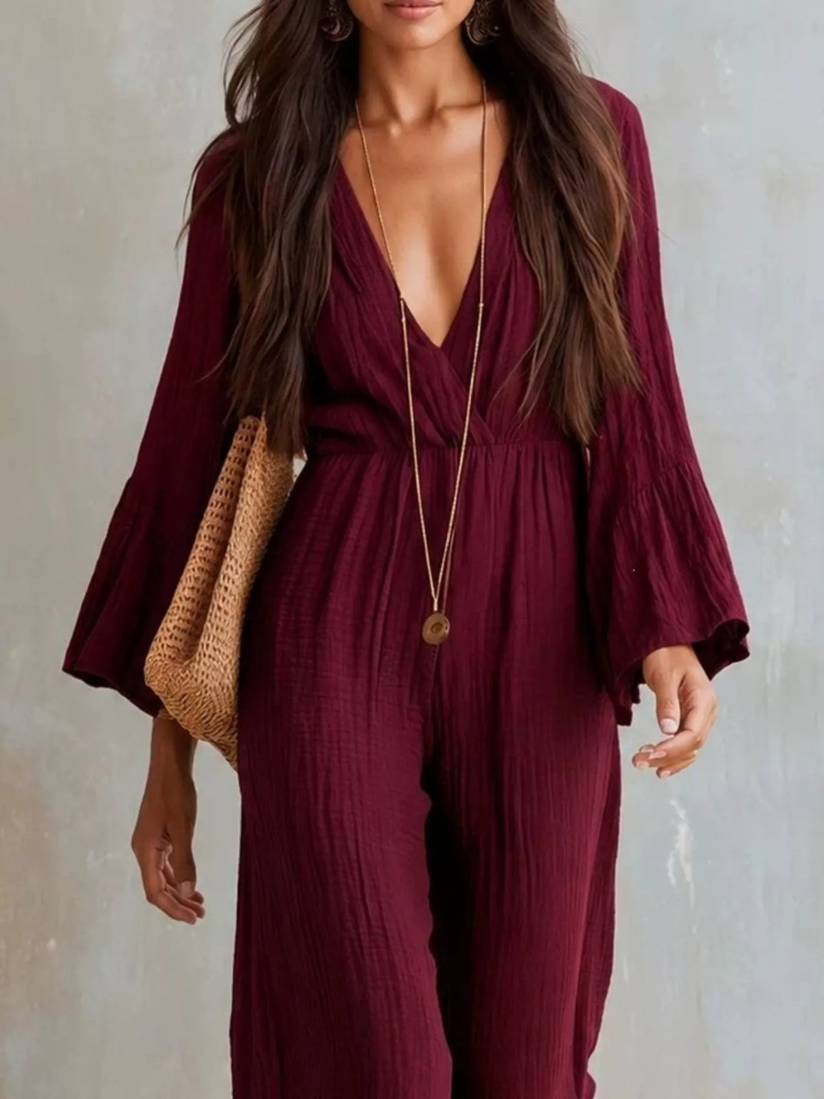 Textured flare sleeve jumpsuit for women with stylish design, featuring a fitted waist and wide-leg silhouette, by Trendsi.