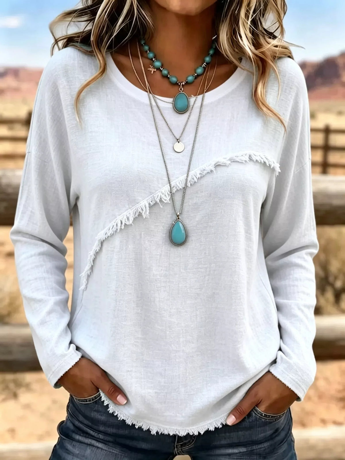 Plus size long sleeve T-shirt with fringe detail, stylish tops by Trendsi, featuring a relaxed fit and casual design.