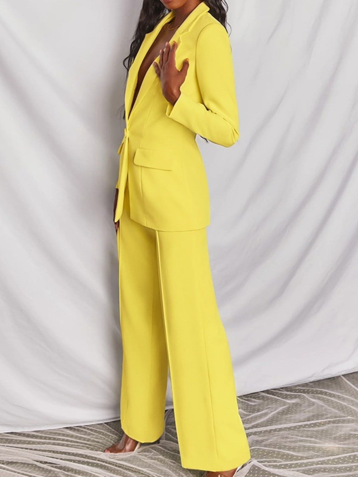 Plus size blazer and wide-leg pants matching set by Trendsi, featuring a one-button blazer and stylish wide-leg trousers.
