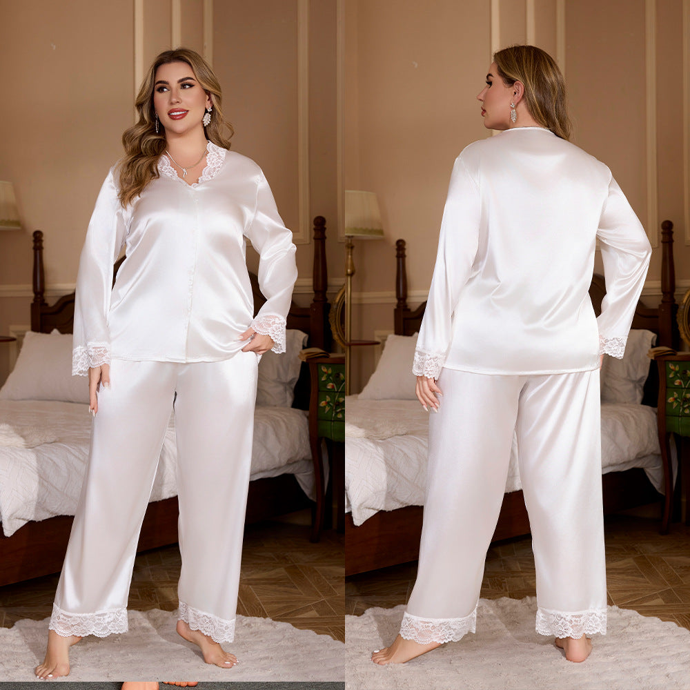 Plus-size white satin pajama set with long sleeves, v-neck, and delicate white lace trim on cuffs and hems.