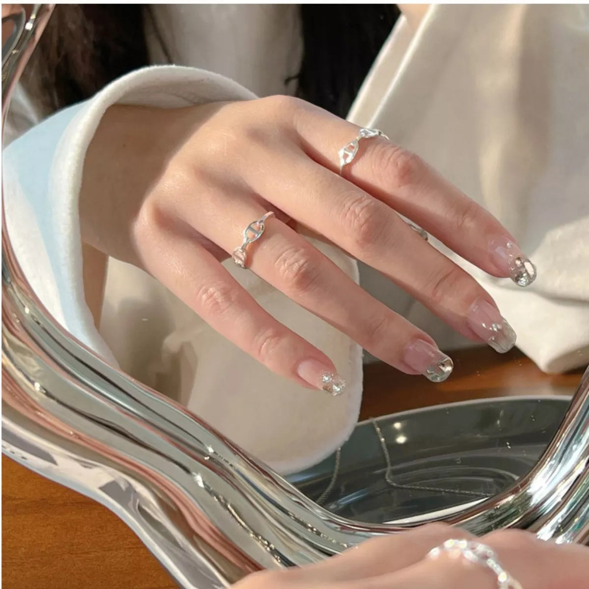Sterling silver geometric ring with modern design, featuring clean lines and polished finish, perfect for stylish jewelry accessories.