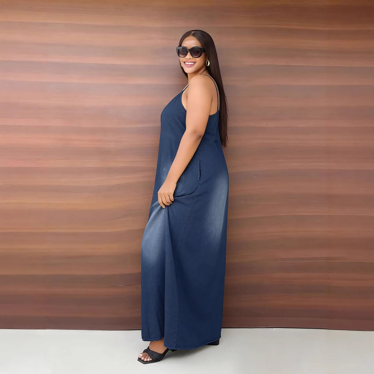 Casual faded denim dress by eprolo featuring side pockets, loose fit, and shoulder straps, styled with a relaxed, trendy look.