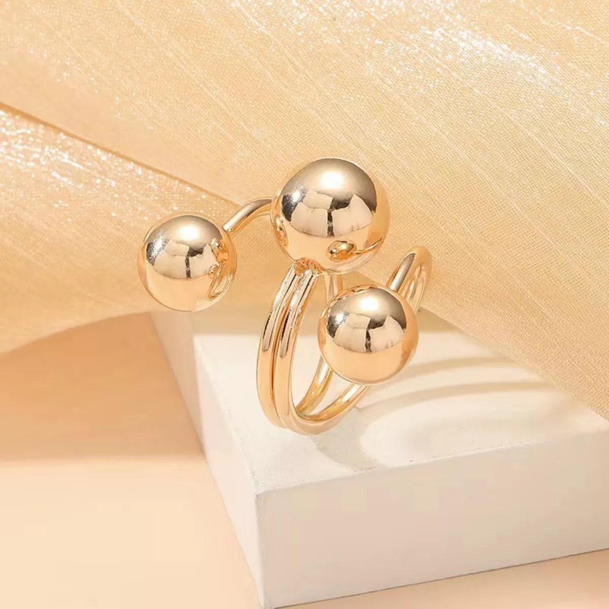 Multi-layered ball ring from Plush Fashion Hub featuring stacked silver-tone metal balls on a sleek ring band.