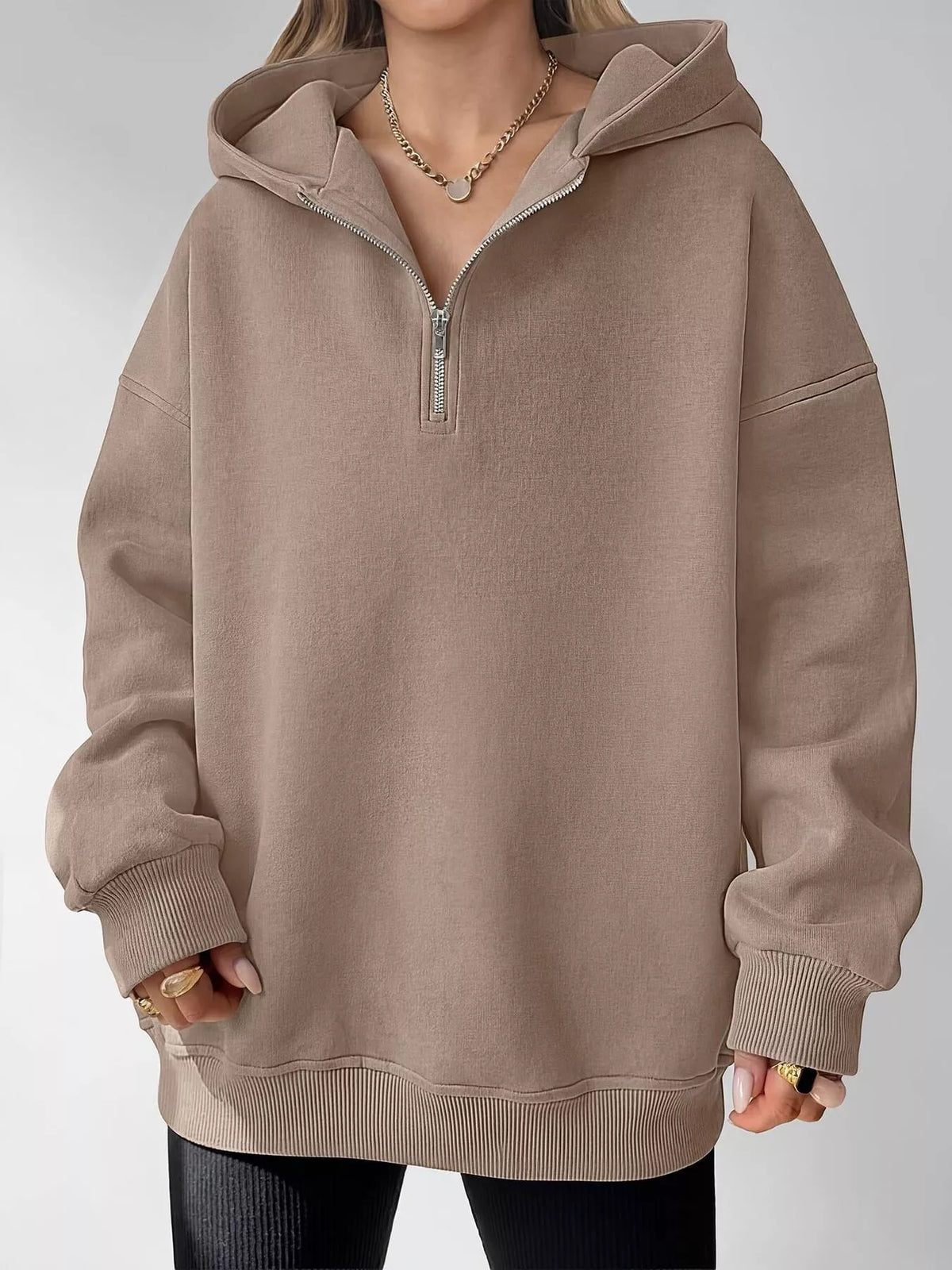 Oversized quarter-zip hoodie from Trendsi, showing a cozy, casual tops style with a relaxed fit and soft fabric in neutral color.