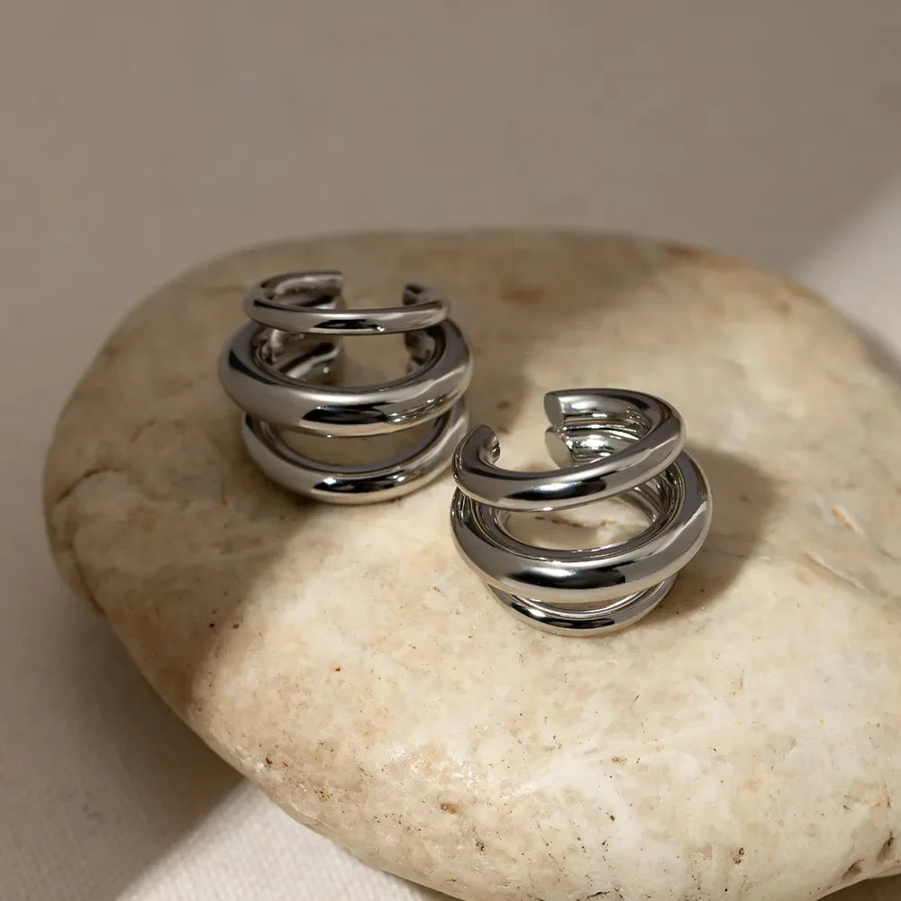 Stainless steel layered cuff earrings from Plush Fashion Hub featuring multiple overlapping metal bands in a modern design.