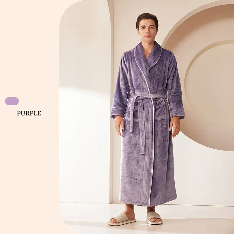 A man wearing a long, plush purple fleece bathrobe with a shawl collar, white piping, and a tie belt.