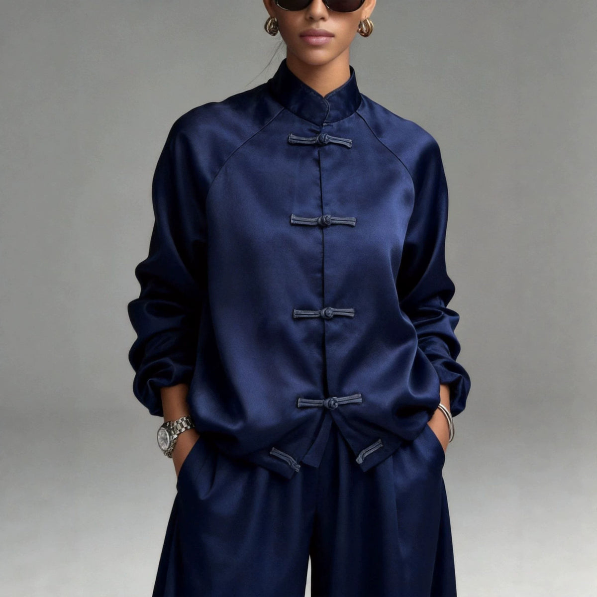 Elegant satin two-piece jumpsuit with hanging wide-leg pants and drawstring waist by eprolo, shown in a stylish, relaxed fit.