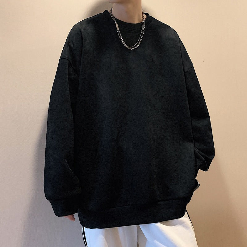 Solid black oversized crewneck sweatshirt in plain faux-suede fabric with a crew neck and cuffed long sleeves.