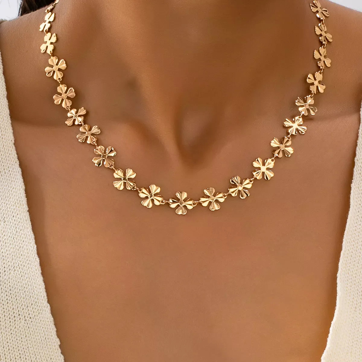 18K gold-plated alloy flower chain necklace featuring delicate floral design and adjustable chain length.
