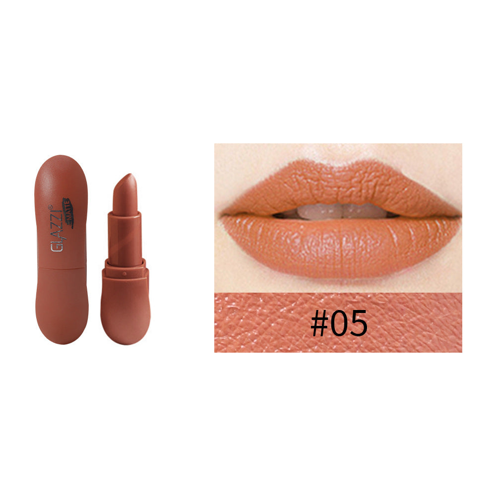 Matte brown lipstick in a pill-shaped plastic case with shade #05 swatch and applied lips.