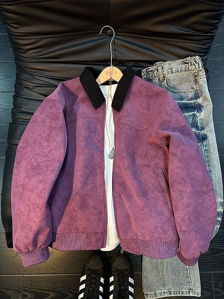Purple suede-like bomber jacket with a black collar and ribbed cuffs, worn over a white shirt and jeans.
