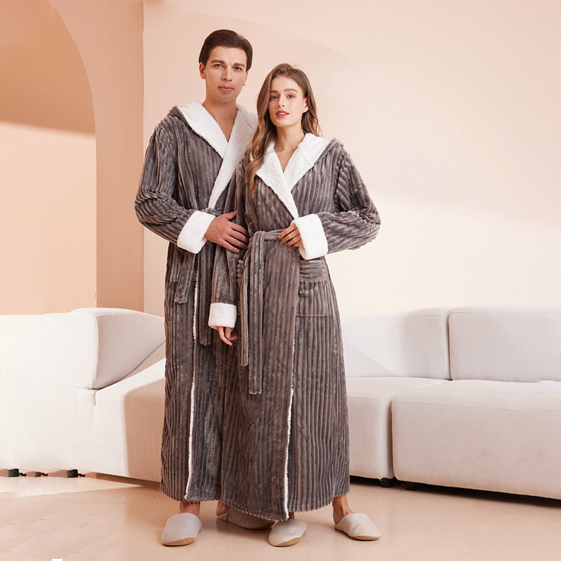 A man and woman wear matching extra-long, grey ribbed bathrobes with white sherpa trim and hoods.