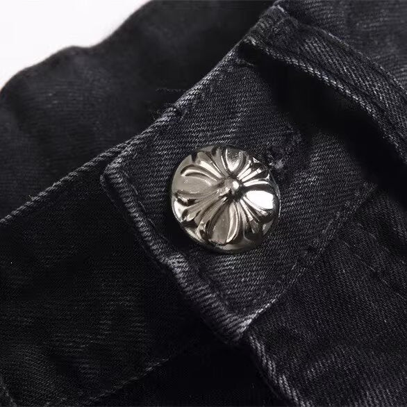 Black denim jeans with a silver floral metal button on the waistband.