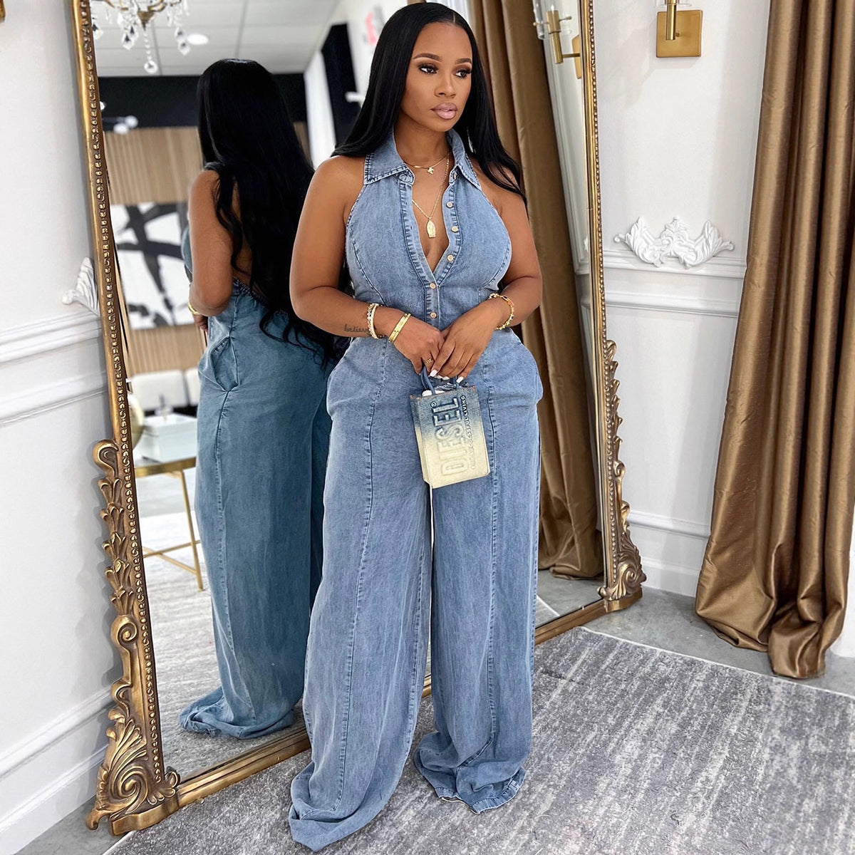 Women's denim jumpsuit with turn-down collar, halter neckline, and single button closure in a Western style by eprolo.