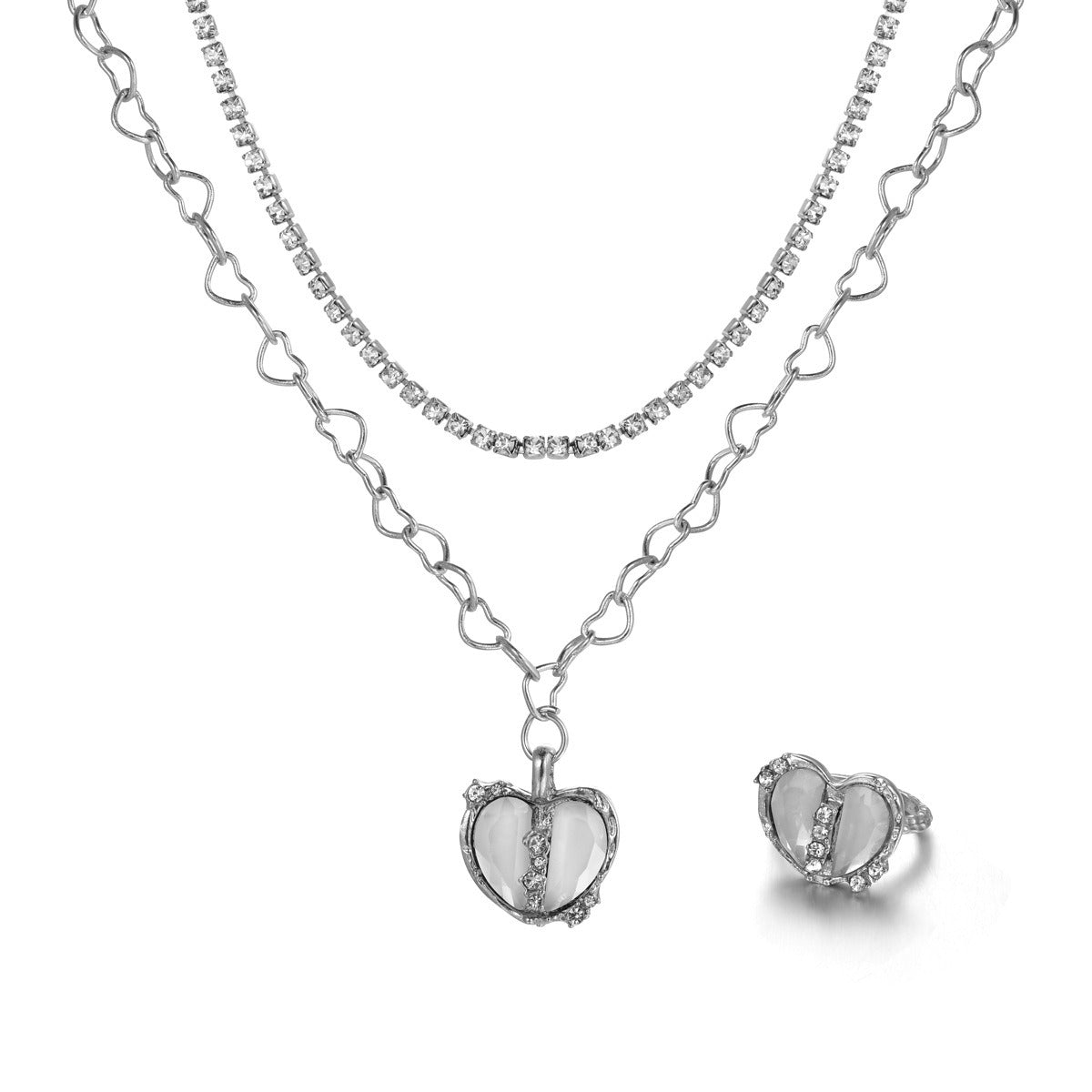A silver jewelry set featuring a layered necklace with a heart-shaped pendant and a matching split heart ring.