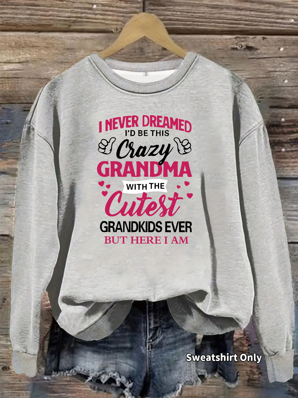 Gray crewneck sweatshirt with pink and black text that reads "I Never Dreamed I'd Be This Crazy Grandma."