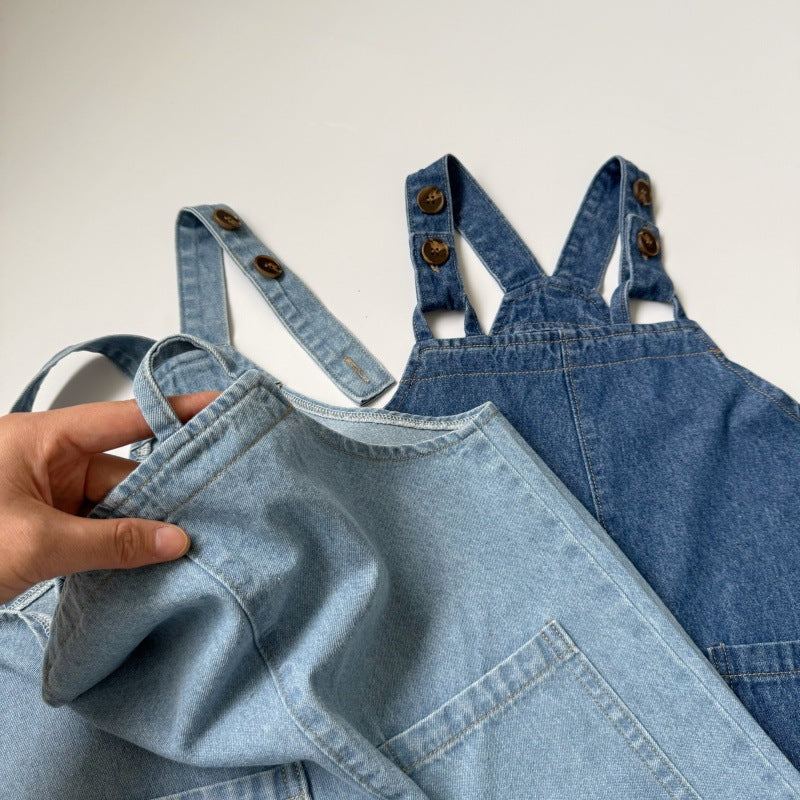 Two denim pinafore dresses in light blue and dark blue, featuring buttoned straps and front pockets.