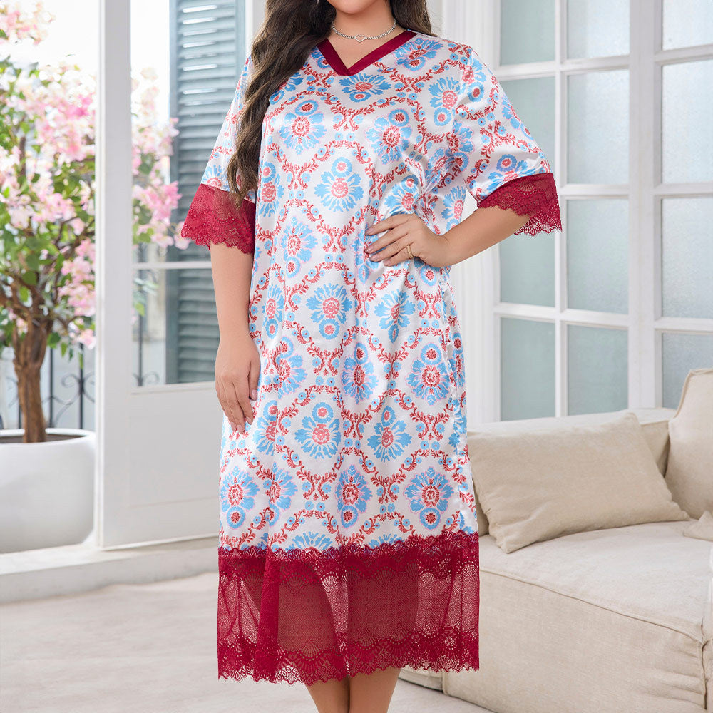 A woman wears a long, silky white nightgown featuring a blue and red floral damask pattern, V-neck, and red lace trim.