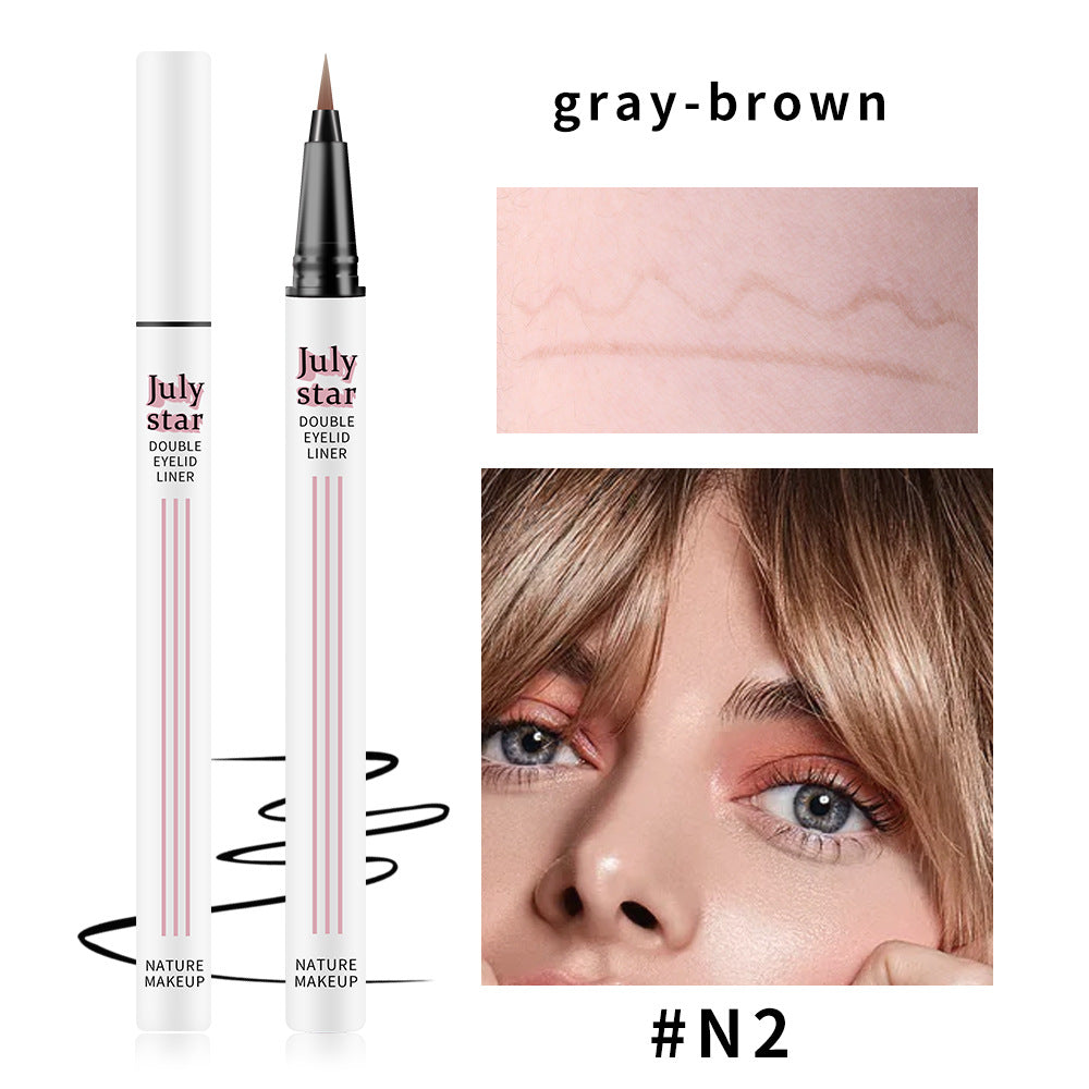 White plastic liquid eyeliner pen with July Star branding, gray-brown shade swatch on skin, and a model wearing makeup.