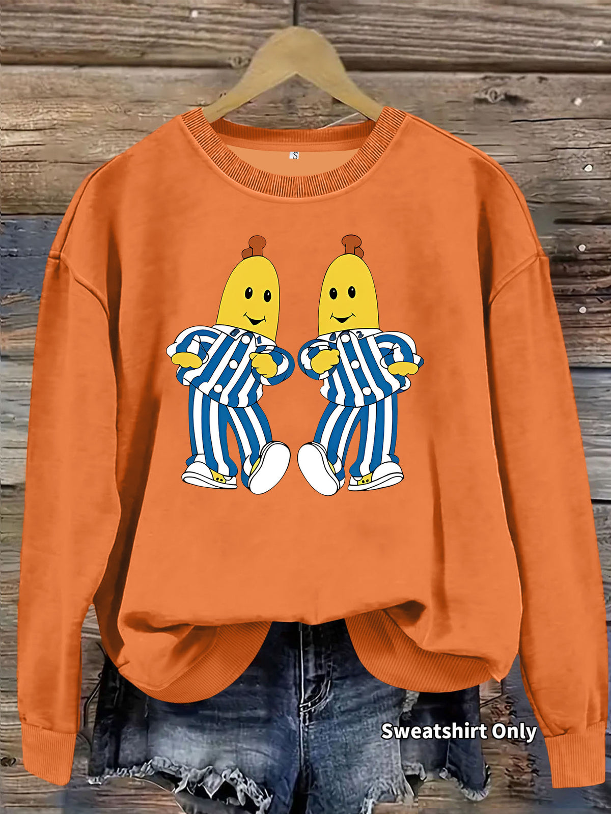 Orange crewneck sweatshirt with Bananas in Pajamas graphic, long sleeves, and ribbed trim.