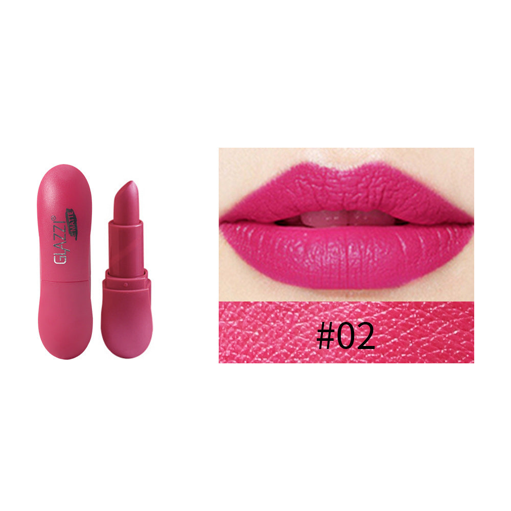 Matte fuchsia lipstick in pill-shaped case with #02 swatch and lip application.