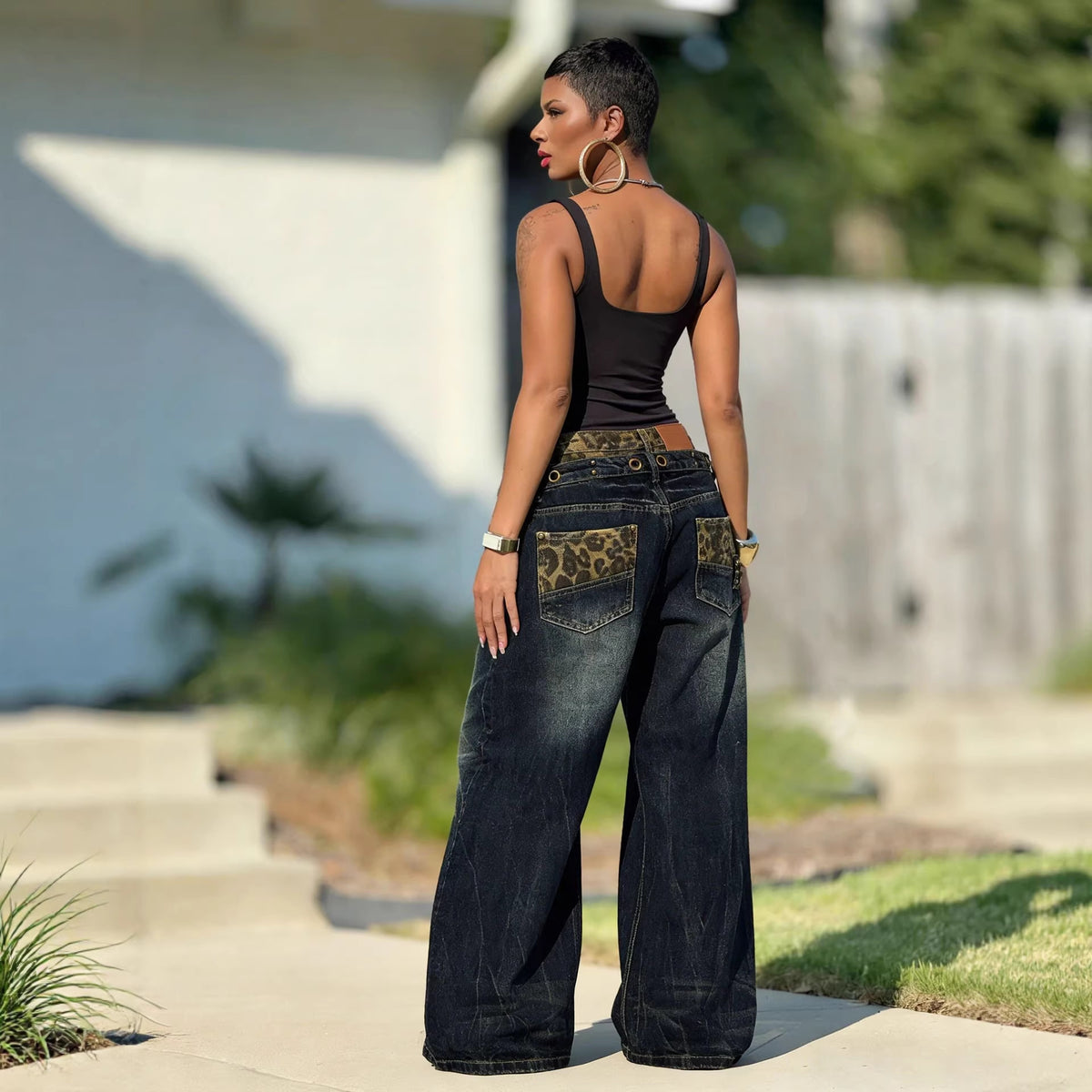 Distressed washed denim pants with leopard print waistband, casual style from eprolo, shown on a model with a relaxed fit.