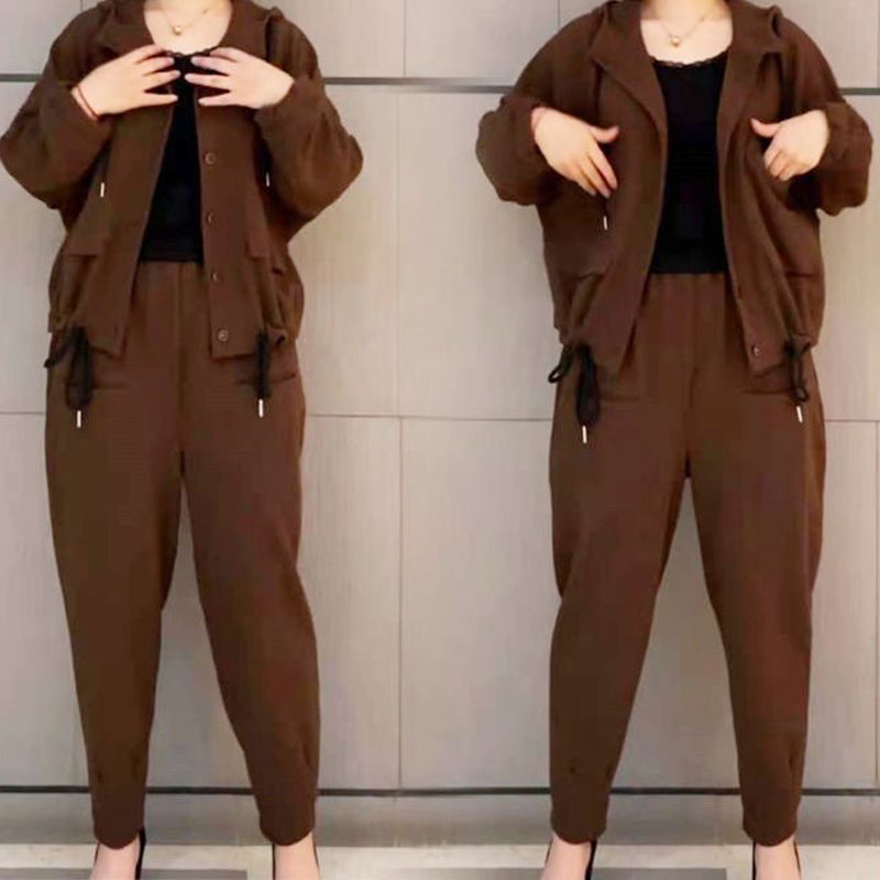 Brown hooded jacket and pants set with drawstring details, worn over a black top.