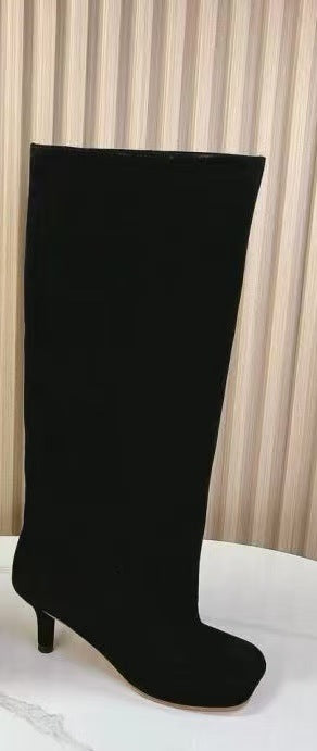 Black suede knee-high boot, solid pattern, pointed toe, and thin stiletto heel.