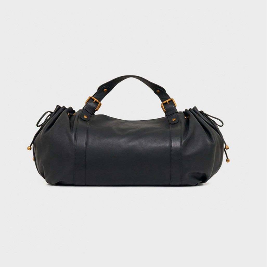 Black leather duffle bag with gold buckles, side drawstrings, and top handles.