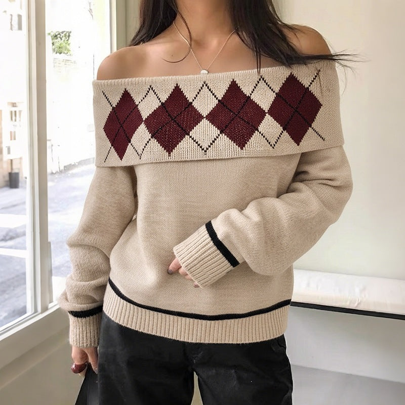Beige knit off-the-shoulder sweater with maroon argyle pattern, black hem stripes, and long sleeves.