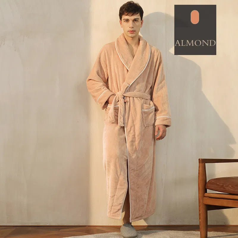 Man wearing a plush, solid beige fleece bathrobe with white piping and a tie belt.