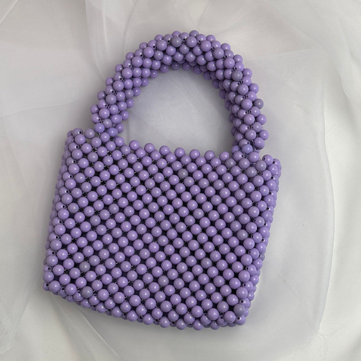 Fashion solid color beaded handbag by eprolo with intricate beaded design and handheld strap, stylish accessory for any outfit.