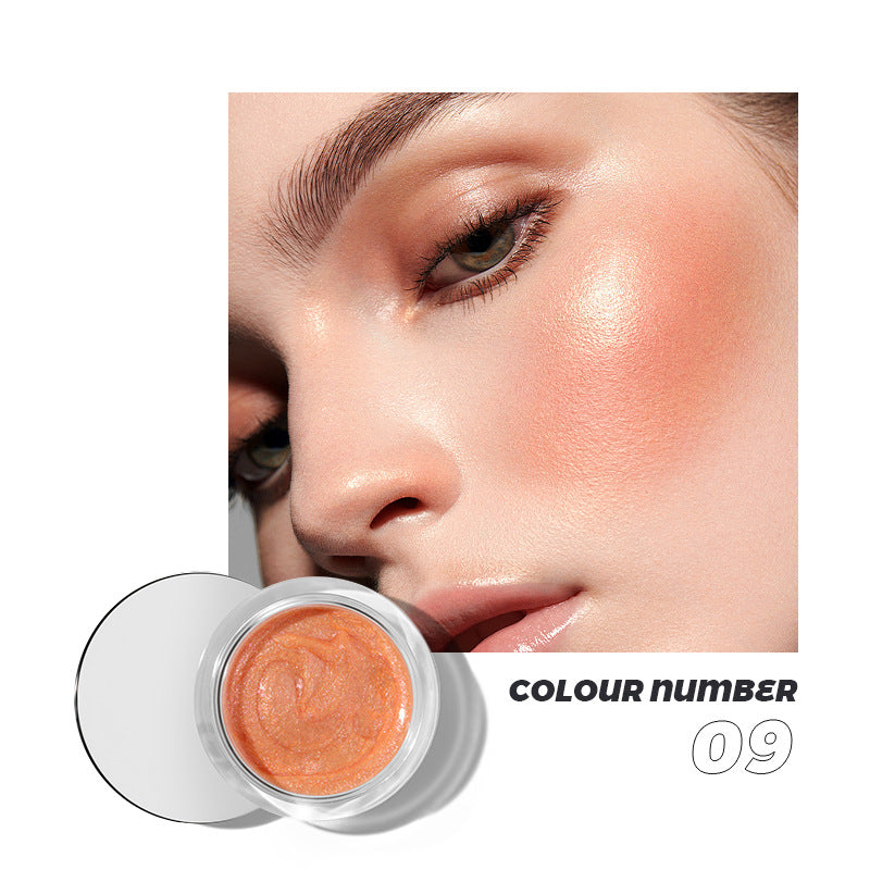 Orange cream blush in a round glass jar with a clear lid, shown next to a model wearing it on cheekbones.