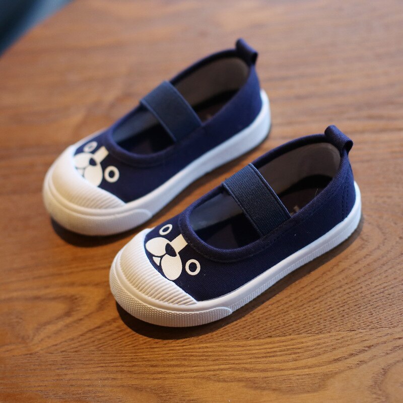 Navy canvas slip-on kids shoes with white rubber toes, elastic straps, and cute dog face prints.