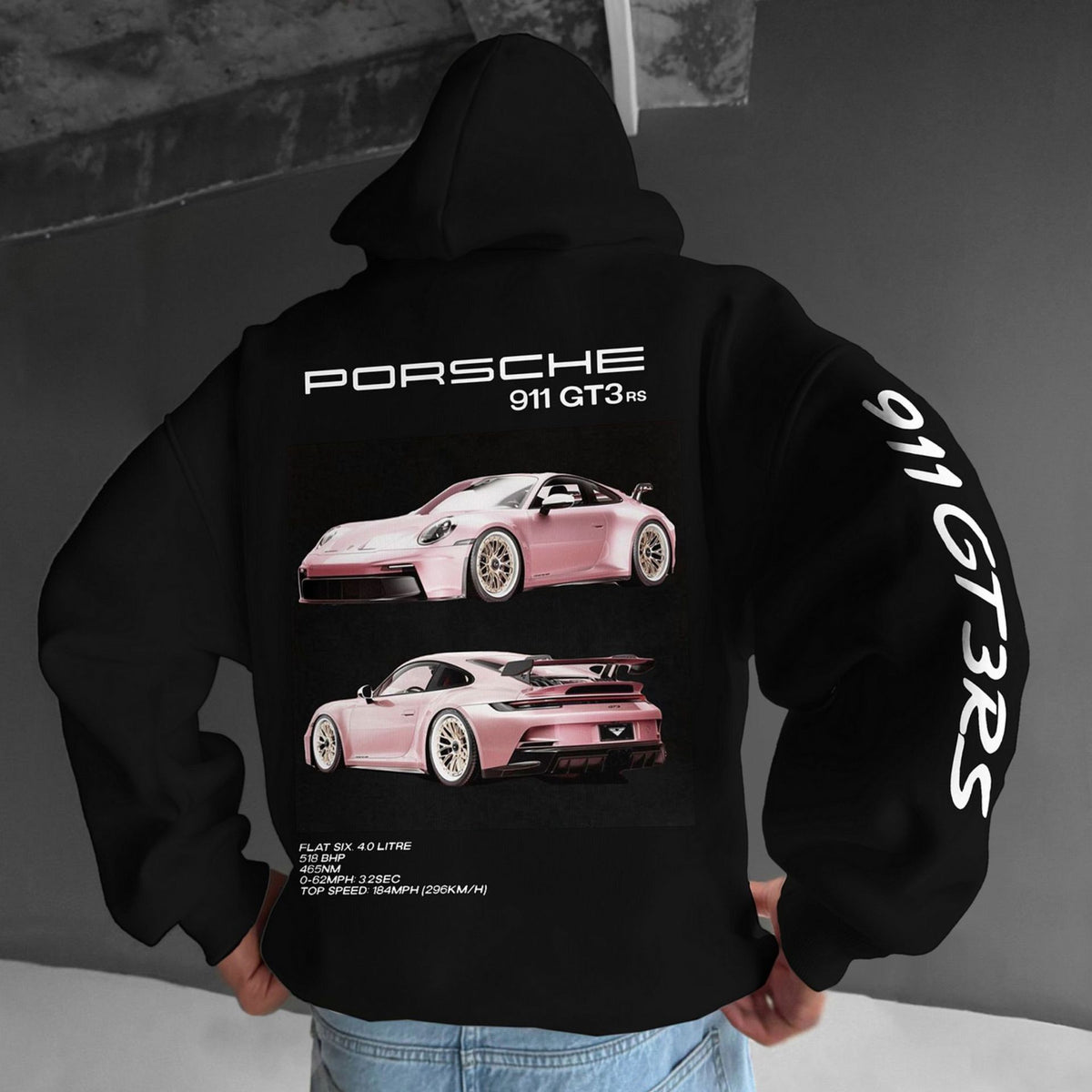 A person wearing a black hoodie with a pink Porsche 911 GT3 RS print on the back.