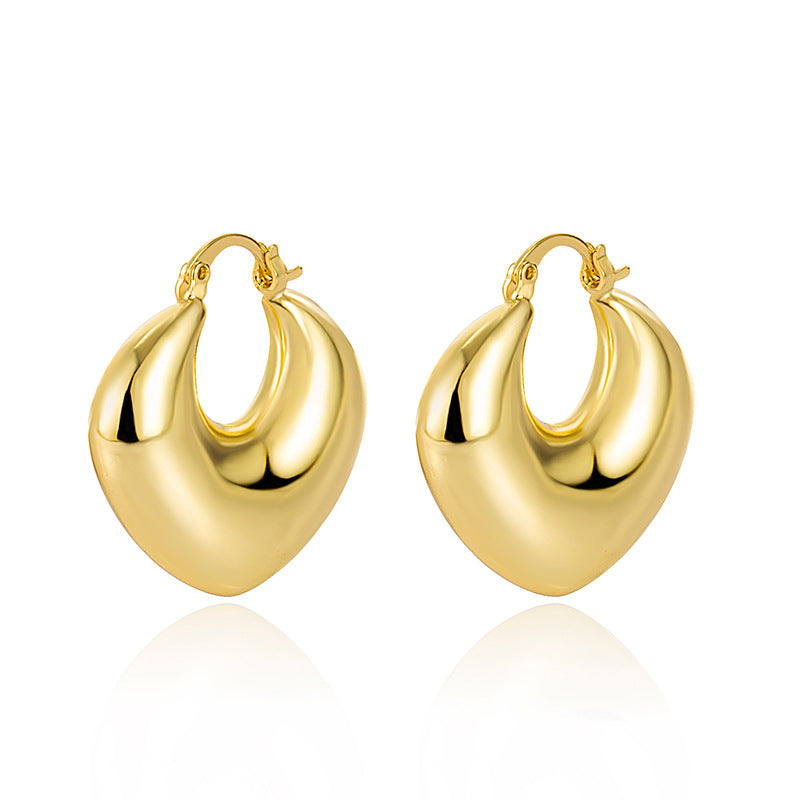 Gold heart-shaped hoop earrings featuring a polished, smooth metal finish with secure latch-back closures.