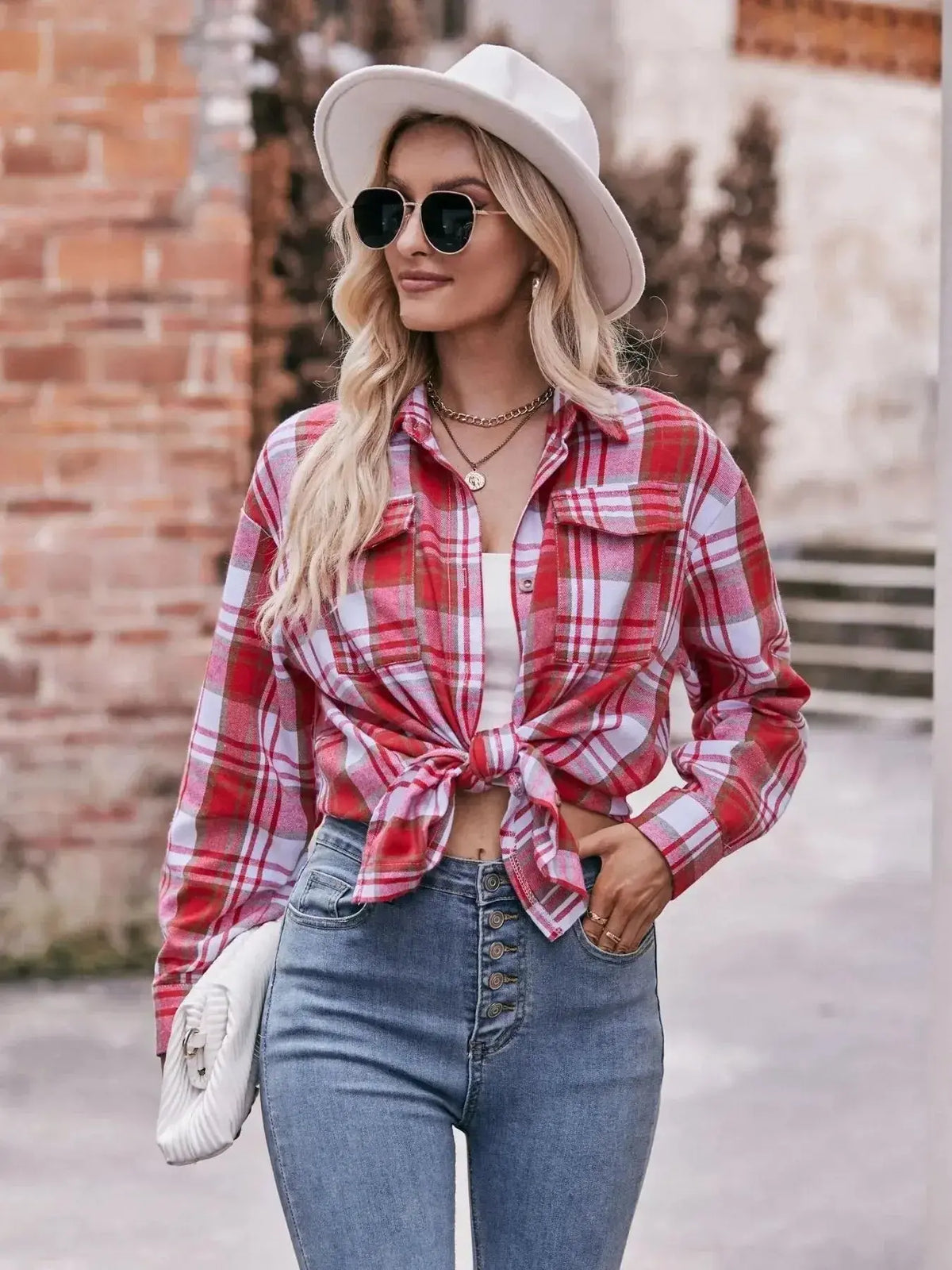 Women’s plaid long sleeve button-down shirt by Plush Fashion Hub, featuring a classic pattern and relaxed fit.