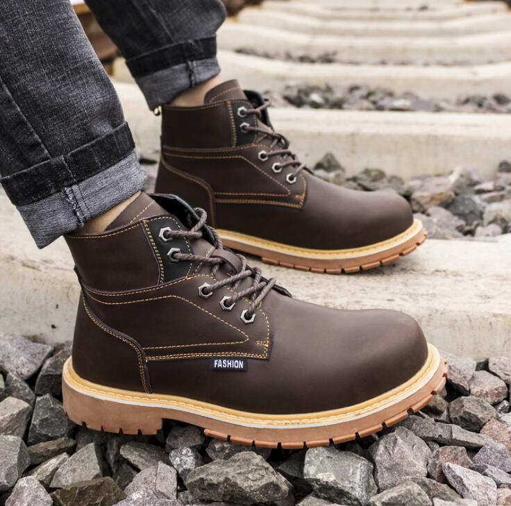 Brown leather work boots with thick lug soles, lace-up closure, metal eyelets, and yellow contrast stitching.